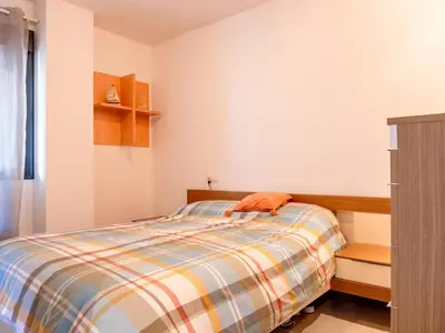 a bedroom with a bed with an orange towel on it at Winahost Apartment Neo Residencial Mediterráneo in Barrio-Mar