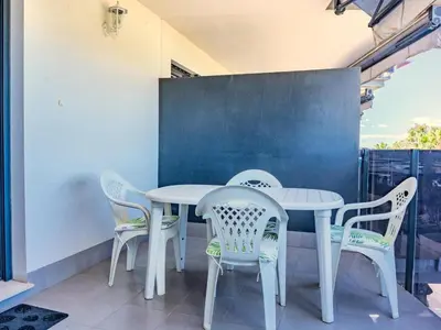 a white table and chairs on a patio at Winahost Apartment Neo Residencial Mediterráneo in Barrio-Mar