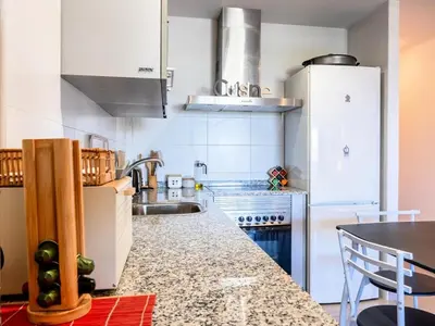 a kitchen with white appliances and a counter top at Winahost Apartment Neo Residencial Mediterráneo in Barrio-Mar