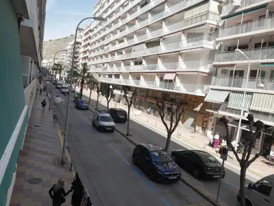 a city street with cars parked in front of a building at Levante, 1-N in Cullera