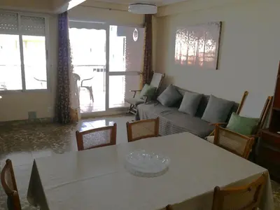 a living room with a table and a couch at Levante, 1-N in Cullera