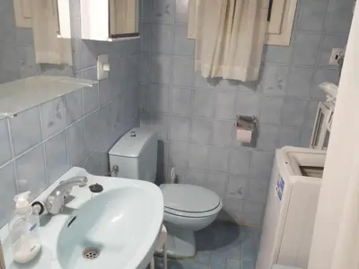a bathroom with a white sink and a toilet at Levante, 1-N in Cullera