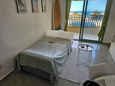 a bathroom with a toilet and a sink and a mirror at Apartamento Brisa Patacona in Valencia