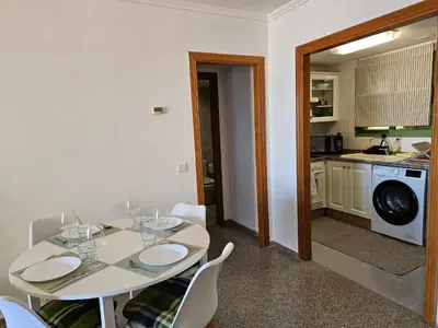 a living room with a table and chairs and a dining room at Apartamento Brisa Patacona in Valencia