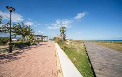 a brick sidewalk next to the beach with a street light at 2 Bedroom Lovely Apartment In Sagunto in Sagunto