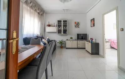 a dining room and living room with a table and chairs at 2 Bedroom Lovely Apartment In Sagunto in Sagunto
