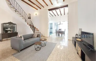 a living room with a couch and a tv at Gorgeous Home In Llaurí With Wifi in Llaurí