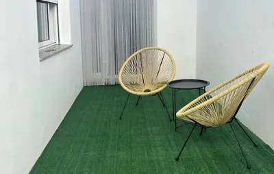 two chairs and a table in a room with green carpet at Gorgeous Home In Llaurí With Wifi in Llaurí
