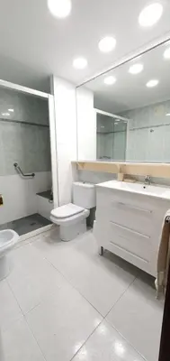 a bathroom with a sink and a toilet and a mirror at Valencia verano in Valencia