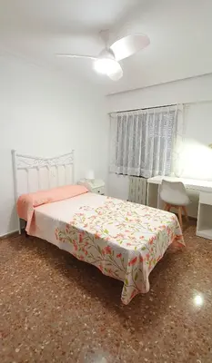 a bedroom with a bed and a table and a desk at Valencia verano in Valencia