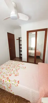 a bedroom with a bed and a ceiling fan at Valencia verano in Valencia