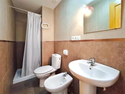 a bathroom with a toilet and a sink at Apartamento con Terraza junto al Mar en Moncofa in Moncófar