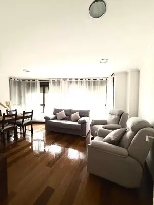 a living room with two couches and a table at Apartment 100m from the beach in Cullera