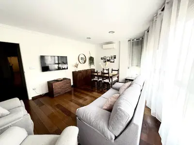 a living room with a couch and a table at Apartment 100m from the beach in Cullera