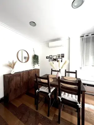 a dining room with a wooden table and chairs at Apartment 100m from the beach in Cullera