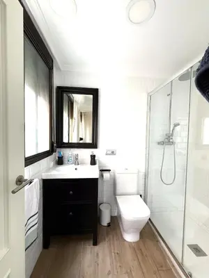 a bathroom with a sink and a toilet and a shower at Apartment 100m from the beach in Cullera