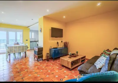 a living room with a couch and a table at Charming Coastal Retreat in Alboraya