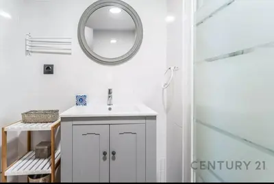 a white bathroom with a sink and a mirror at Charming Coastal Retreat in Alboraya