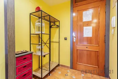 a kitchen with a red cabinet next to a door at Charming Coastal Retreat in Alboraya