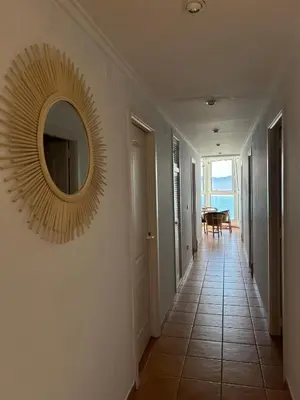 a hallway with a mirror on the wall at Vila 