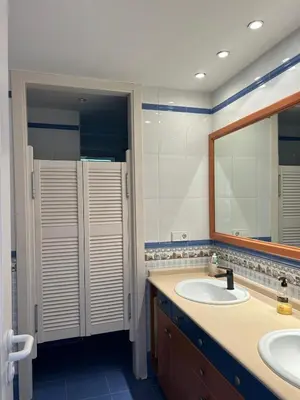 a bathroom with two sinks and a large mirror at Vila 
