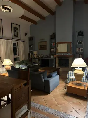 a living room with a couch and a table at Vila 