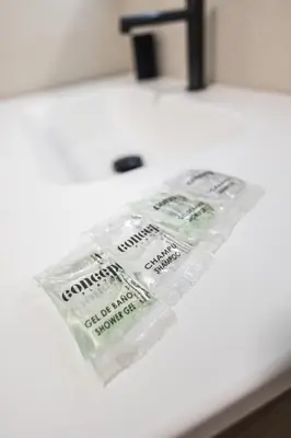 two packages of toothpaste sitting on top of a counter at Arm Suites by Concept Flats in Valencia