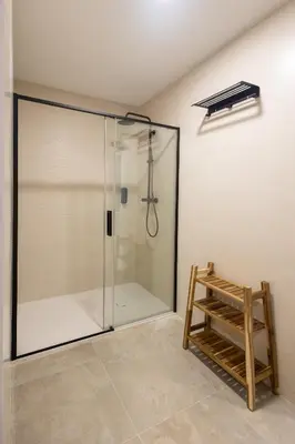 a shower with a glass door in a bathroom at Arm Suites by Concept Flats in Valencia
