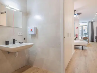 a white bathroom with a sink in a room at Winahost Apartamento Benimaclet 1 in Valencia