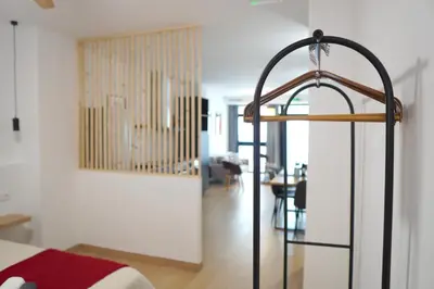 a bedroom with a bed and a dining room at Céntrico & Lujoso in Valencia