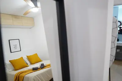 a bedroom with two beds with yellow pillows at Céntrico & Lujoso in Valencia
