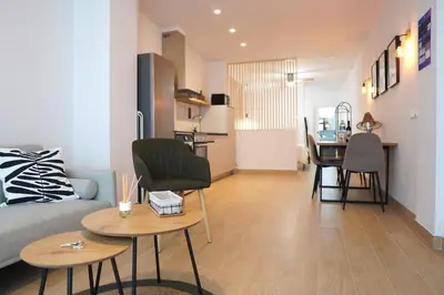 a living room with a couch and tables and a kitchen at Premium & Céntrico in Valencia