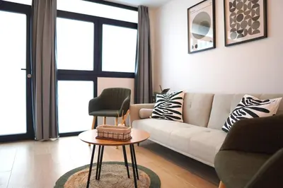 a living room with a couch and a chair at Premium & Céntrico in Valencia