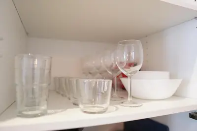 a shelf with wine glasses and bowls on it at Premium & Céntrico in Valencia