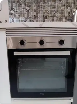 a white stove with an open oven in a kitchen at Sueños en la playa in Valencia