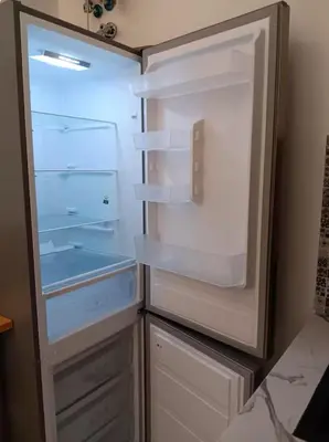 an empty refrigerator with its door open in a kitchen at Sueños en la playa in Valencia