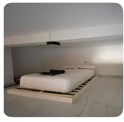 a white bed in a white room with at Sueños en la playa in Valencia