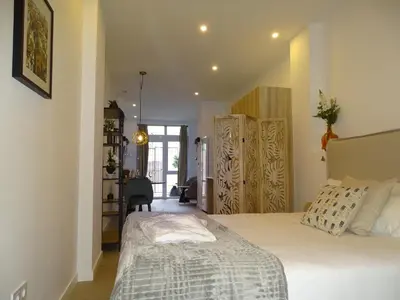a bedroom with a bed and a chair in it at MDB 52A - Loft Valencia in Valencia