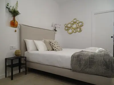 a bedroom with a large white bed with pillows at MDB 52A - Loft Valencia in Valencia