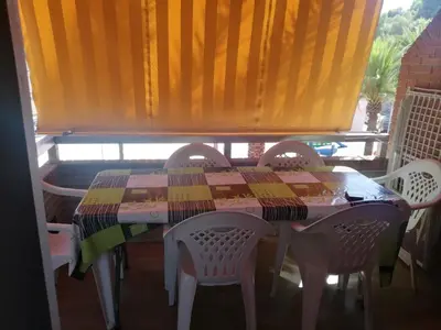 a table and chairs with a table and a window at Apartamento en el faro de Cullera in Cullera