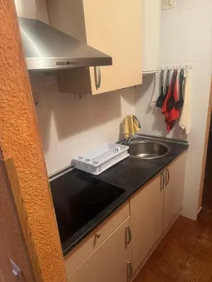 a small kitchen with a sink and a counter top at Apartamento en el faro de Cullera in Cullera