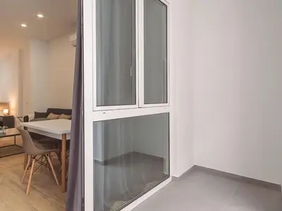 a glass cabinet in a living room with a table at Central Apartment in Benimaclet 2 in Valencia