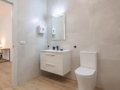 a white bathroom with a toilet and a sink at Central Apartment in Benimaclet 2 in Valencia