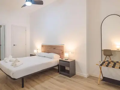 a bedroom with a bed and a desk and a mirror at Central Apartment in Benimaclet 2 in Valencia