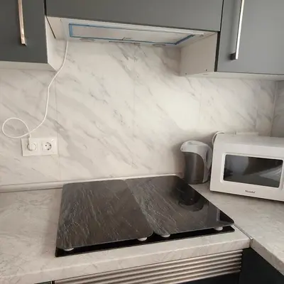a kitchen with a stove and a microwave at Piso A playa 19 in Puerto de Sagunto