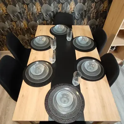 a table set with black plates and glasses at Piso A playa 19 in Puerto de Sagunto