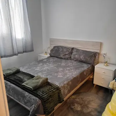 a small bedroom with a bed and a couch at Piso A playa 19 in Puerto de Sagunto