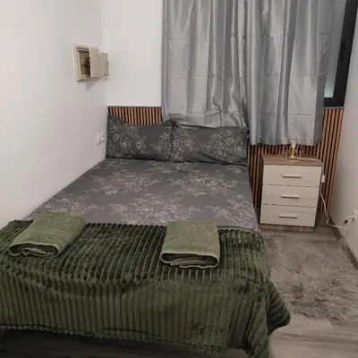 a bed in a small room with a window at Piso A playa 19 in Puerto de Sagunto