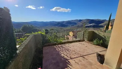 a balcony with a gate and a view of the mountains at Casa Rural Torás Piscina, BBQ, Chimenea y WiFi 600Mb in Torás