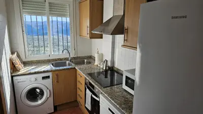a kitchen with a sink and a washing machine at Casa Rural Torás Piscina, BBQ, Chimenea y WiFi 600Mb in Torás